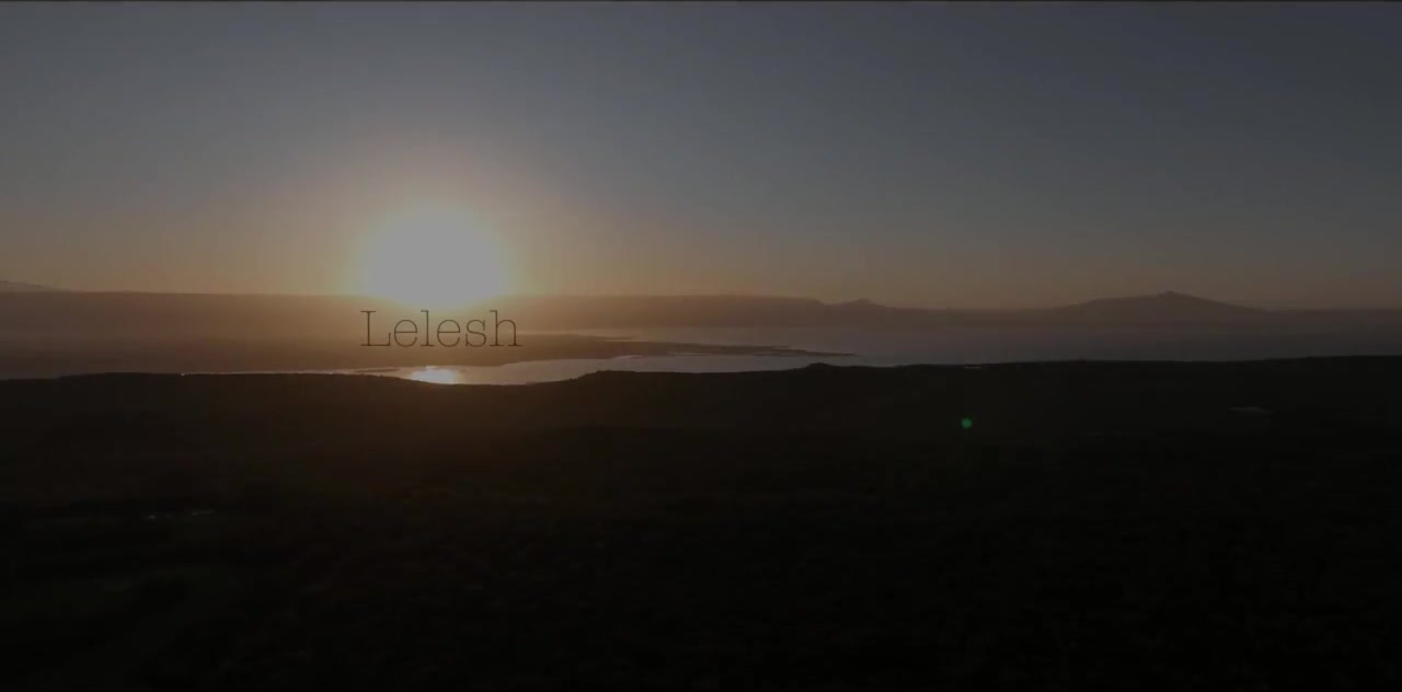 Sunrise over Lake Naivasha — first light on still water, birds crossing the horizon.